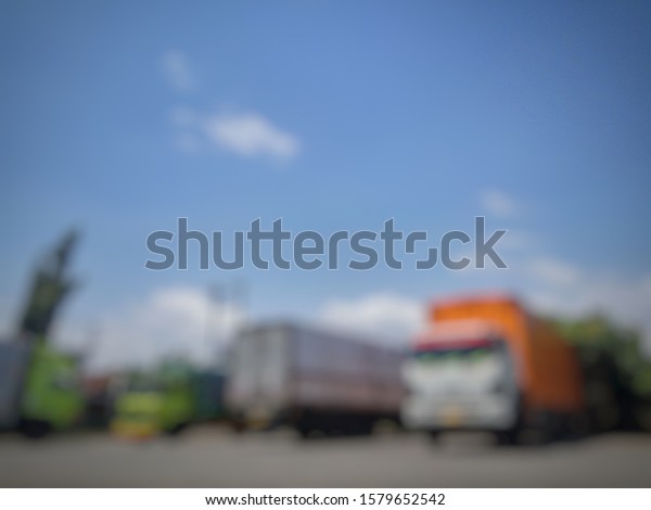 Blurred image of a trucks parked for loading\
and unloading