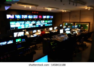 Blurred Image Of The TV Production Team In The Broadcast Control Room, Which Includes Video Switch And Audio Mixer, Control Broadcasts In Recording Studio.