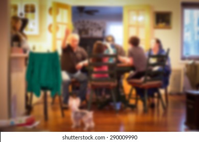 blurred image of Typical American family gathered around kitchen table - Powered by Shutterstock