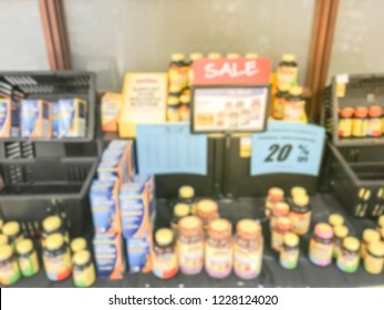 Blurred Image Variation Of Vitamin And Supplement On Shelves Display With Discounted Price Tags At Grocery Store In Texas, America.