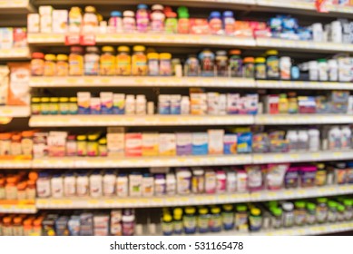 Blurred image of vitamin store shelves with huge variation of vitamins and supplements, natural remedies, functional food, lifestyle support, and herbal. Medical supplies product abstract background.