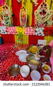 Blurred image of Vog, prasad, or sacred worshipped food, being distributed to devotees, after worshipping idol of God Jagannath, Balaram and Suvodra inside pandal. Howrah, West Bengal, India.