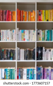 Blurred Image Of White Wooden Bookcase Filled With Books In A UK Home Setting