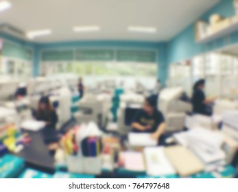 Blurred Image Of Worker Is Working At Modern Office Copy Documents On Machine For Copy, Document Printing And Pagemaking For A Book. Vintage Tone