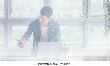 Blurred image, Young designer programming websites and mobile applications on the phone on workplace in office, Search Engine Optimization, lifestyle man and technology communication