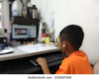 Blurred Images. Children Sitting On A Computer, If Taking Too Long, May Lose Sight.