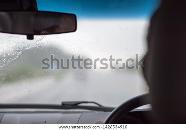 Blurred images of fast driving Up\
the mountain at Rainy season. View from the inside of the\
car