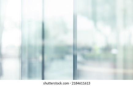 Blurred images of glass wall with city town background.modern abstract window for banner design
