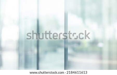 Blurred images of glass wall with city town background.modern abstract window for banner design
