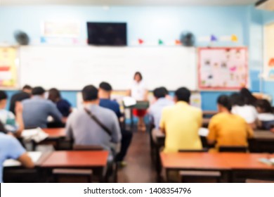 Blurred images of parents sitting in the classroom to talk to class teachers.