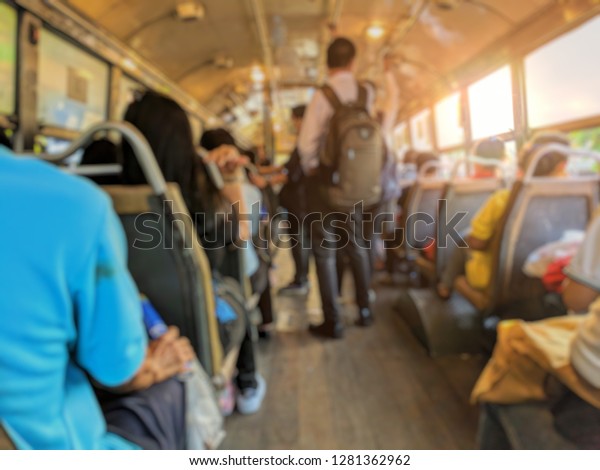 Blurred images, people on bus, Passengers on\
economy class buses in Bangkok\
Thailand