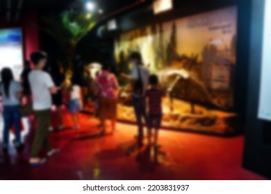 Blurred Images Of People Visiting The Triceratops Dinosaur Of The Cretaceous Period Exhibition In The Geological Museum Of Natural History.