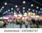 Blurred images of trade fairs in the big hall. image of people walking on a trade fair exhibition or expo where business people show innovation activity and present products in a big hall.