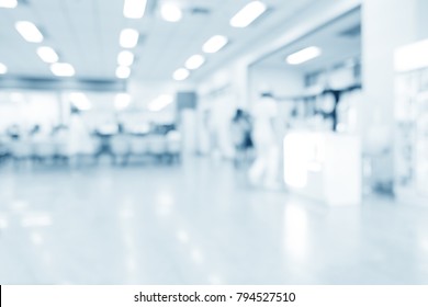 Blurred interior of hospital or clinical with people - abstract medical background.