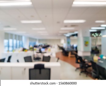 Blurred Interior Of Modern Office Workplace A Workspace Design Without Partition Decorate With Black, White And Wooden Furniture. Nice Environment Can Create Work Productivity, Relax Mood.