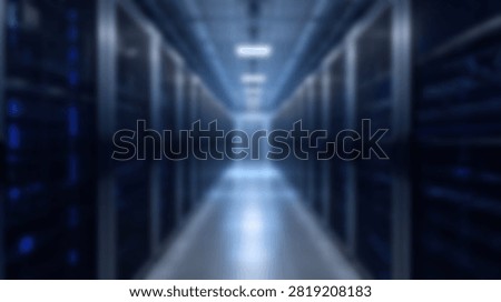 A blurred interior view of a high tech server room corridor with computer racks and blue lights