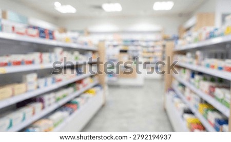 A blurred interior view of a pharmacy showcasing shelves stocked with various medications and health products, providing a sense of busy pharmacy environment.