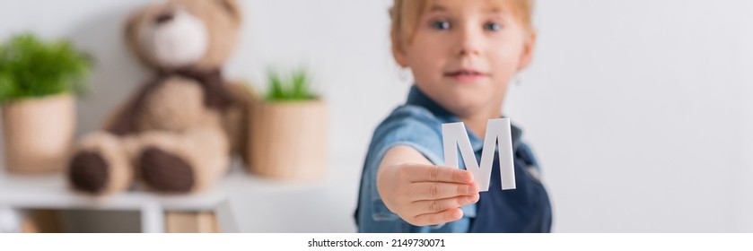 Blurred Kid Holding Letter In Classroom, Banner