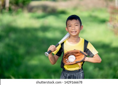 Blurred Kids Boy Playing Baseball On Green Grass Background