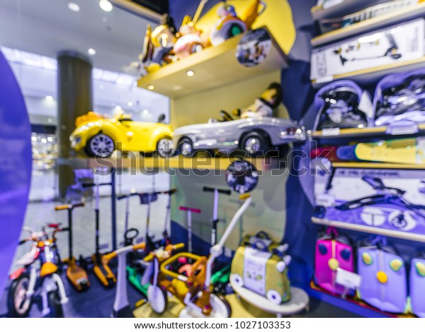 Blurred of kids toy\
store background with bokhe. Purple and yellow colors of toys shop\
interior, copy space