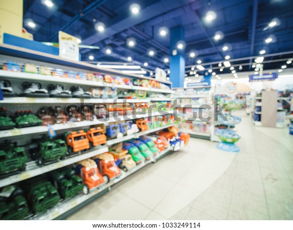 Blurred of\
kids toy store background with bokhe. shelves with cars and aisle\
of kids toy shop interior, copy\
space