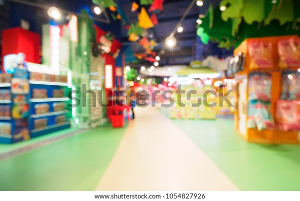 Blurred of kids toy\
store background with bokhe. Purple and yellow colors of toys shop\
interior, copy space