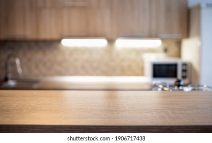 Blurred Kitchen Interior And Wooden Desk Space Home Background