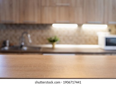 blurred kitchen interior and wooden desk space home background - Shutterstock ID 1906717441