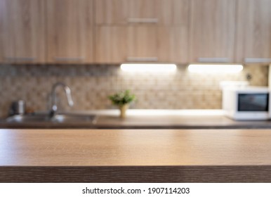 blurred kitchen interior and wooden desk space home background - Shutterstock ID 1907114203