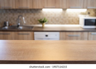 blurred kitchen interior and wooden desk space home background - Shutterstock ID 1907114215