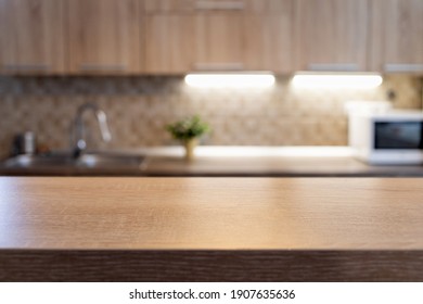 blurred kitchen interior and wooden desk space home background - Shutterstock ID 1907635636
