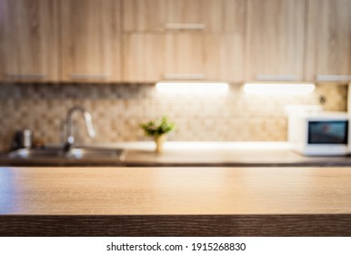 blurred kitchen interior and wooden desk space home background - Shutterstock ID 1915268830