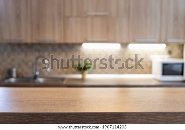 blurred kitchen interior and wooden desk space
home background