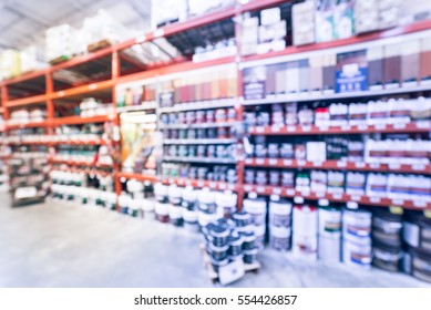 Blurred Large Hardware Store In America. Defocused Interior Home Improvement Retailer, Racks, Rows Of Interior Paint, Exterior Paint/stain, Floor Paint/stain Cans And Building Materials. Vintage Tone.