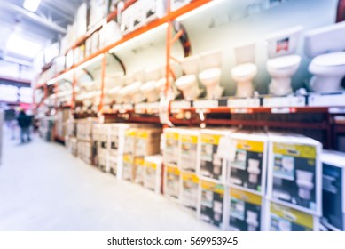 Blurred Large Hardware Store In America. Defocused Interior Home Improvement Retailer, Racks, Rows Of Toilet Seats, Bowls, Bidets, Lids, Ducting, Water Heaters And Building Materials. Vintage Tone.