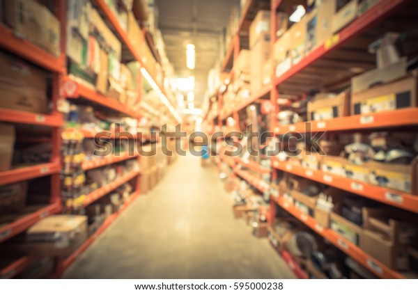 Blurred a large hardware store. Defocused interior\
of home improvement retailer with aisles, shelves, racks of tool\
for house repair from floor to ceiling. Inventory, wholesale\
concept. Vintage tone.