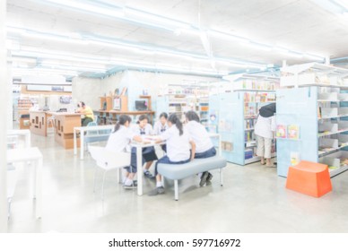 Blurred in library looking book - Shutterstock ID 597716972