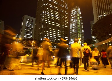 Blurred Light Motion People Walk On Street In The City Night