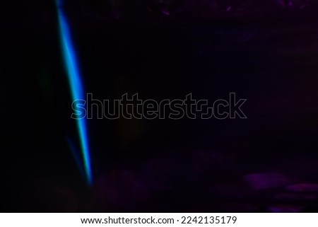 Blurred Light painting one exposure in camera. light glares with a spectral gradient on a dark background. Multicolored abstract colorful line. Unusual light effect.
