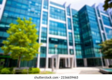 Blurred Luxury Building Exterior With Blue Glass Windows In Business City Center. Corporate Urban Buildings Blurry Background