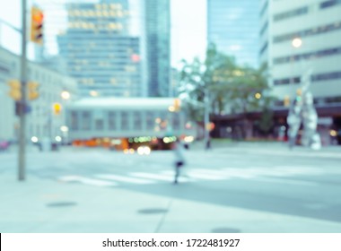 Blurred A Man Crossing The Street In The City With Traffics Light Bokeh And Buildings For Background