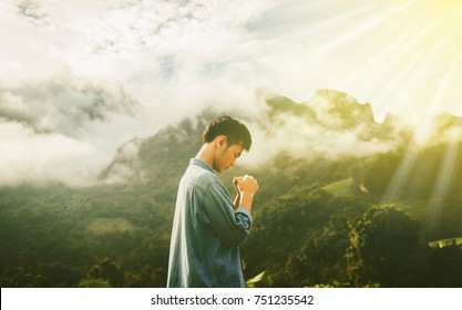A blurred of Man pray in morning with sunlight,Have reletionship with God