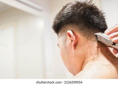 Blurred, Man Using Electric Hair Clipper For Self Hair Cut.