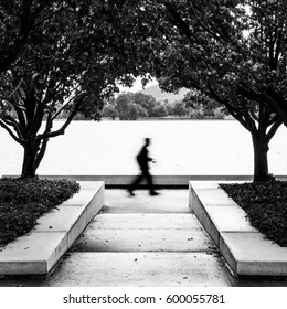 Blurred Man Walking Alongside Lake Burley Griffin Canberra.