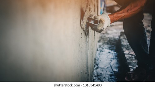 Blurred mason rural thailand Plastering concrete to build wall background industrial worker with plastering tools renovating house concept quality, professional of skilled labor construction industry