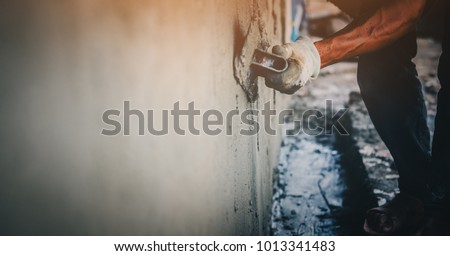 Blurred mason rural thailand Plastering concrete to build wall background industrial worker with plastering tools renovating house concept quality, professional of skilled labor construction industry