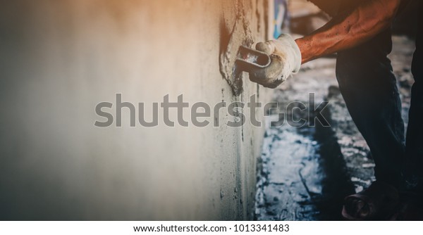 Blurred mason rural thailand Plastering concrete\
to build wall background industrial worker with plastering tools\
renovating house concept quality, professional of skilled labor\
construction industry