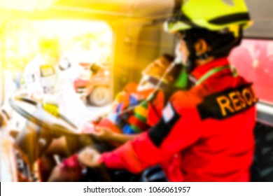 Blurred Medical Commander Of Emergency Response Team And Rescue Team Save Life The Patient And Moving The Patient Out Of The Accident In Car To Ambulance Transfer To The Hospital, CPR Training .