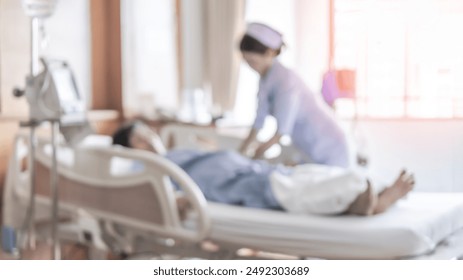 Blurred medical nurse nursing patient on hospital bed blur background, blurry interior white room ward with hospital health care service or healthcare recovery treatment - Powered by Shutterstock