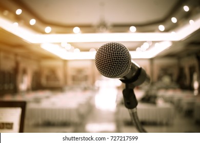 Blurred Of Microphones In Seminar Room, Talking Speak In Conference Hall Light With Microphone And Keynote. Speech Is Vocalized Form Of Communication Humans.